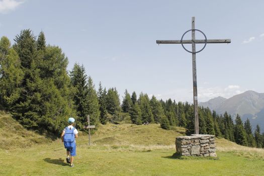 a child and mountain cross