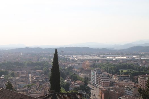 Aerial panoramic view of old historical city centre of Brescia city with churches, towers and medieval buildings with red tiled roofs, Lombardy, Northern Italy. Cityscape of Brescia town.