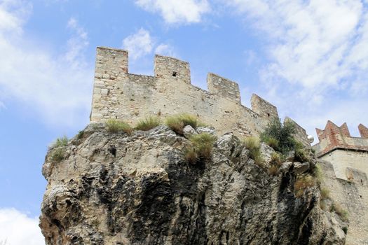 Ancient castle wall with tower in Malcesine on Garda Lake, Italy