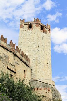 Ancient castle wall with tower in Malcesine on Garda Lake, Italy