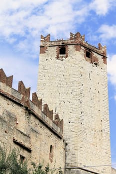 Ancient castle wall with tower in Malcesine on Garda Lake, Italy