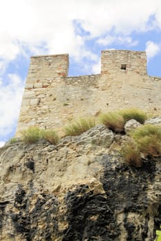 Ancient castle wall with tower in Malcesine on Garda Lake, Italy