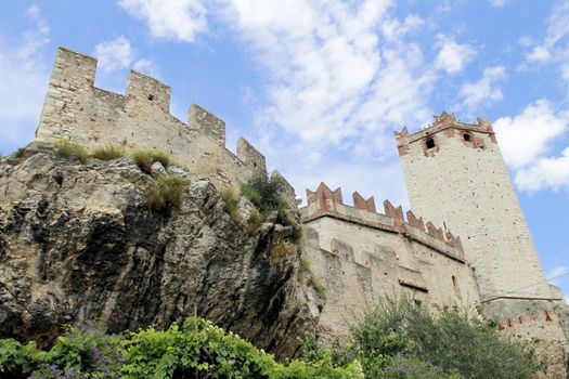 Ancient castle wall with tower in Malcesine on Garda Lake, Italy