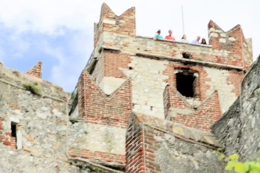 Ancient castle wall with tower in Malcesine on Garda Lake, Italy