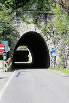 Scenic panoramic beltway road around lake Garda full of tunnels and galleries made in the rocks at the edge of a coastline