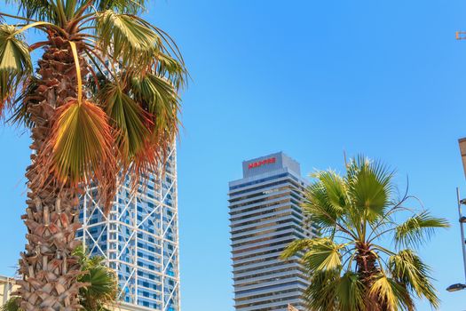 Barcelona, Spain - June 21, 2017 : architectural detail of the MAPFRE tower during the summer, a skyscraper designed by the architects Inigo and Enrique de Leon and built for the 1992 Summer Olympics