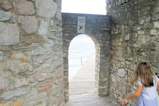 ancient stone gate on the lake in Italy