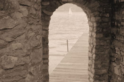 ancient stone gate on the lake in Italy