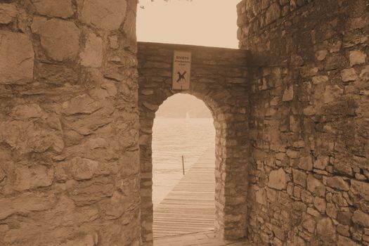 ancient stone gate on the lake in Italy