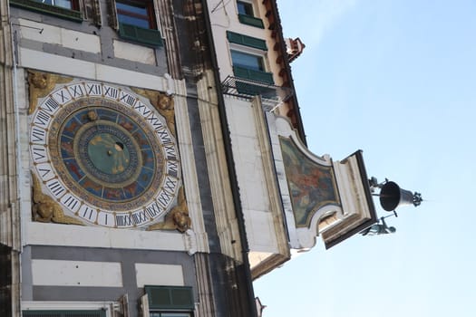 the clock tower with historical astronomical clock in Brescia, Italy