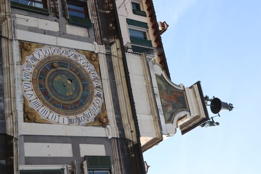 the clock tower with historical astronomical clock in Brescia, Italy