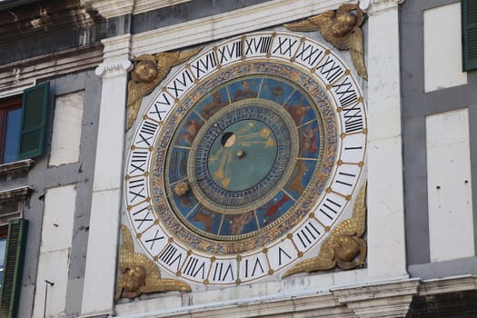 the clock tower with historical astronomical clock in Brescia, Italy