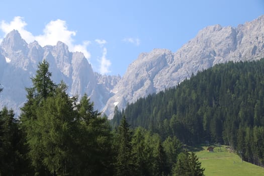 Rocky mountains with green forests at Lago di Braies. Braies lake in the Dolomites in South Tyrol, Italy, a municipality of Braies, in the Prague Valley.