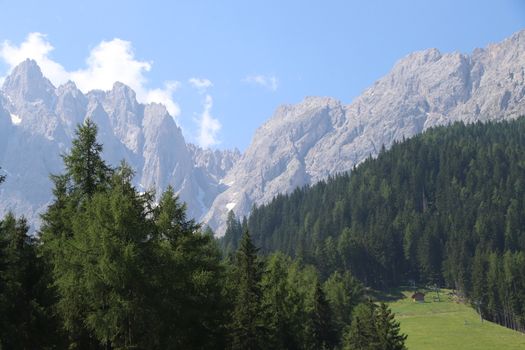 Green valley nature landscape. Mountain layers landscape. Summer in mountain meadow landscape. Meadows and mountains landscape. Blue mountains layers landscape. Beauty in nature. Landscape. Mountains. Valley nature.