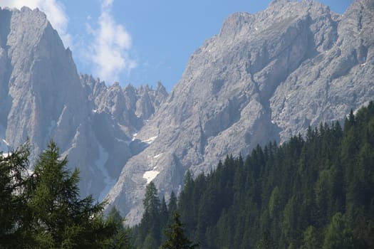 Rocky mountains with green forests at Lago di Braies. Braies lake in the Dolomites in South Tyrol, Italy, a municipality of Braies, in the Prague Valley.