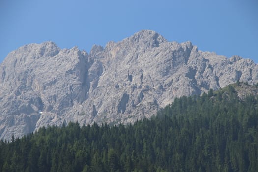 Rocky mountains with green forests at Lago di Braies. Braies lake in the Dolomites in South Tyrol, Italy, a municipality of Braies, in the Prague Valley.