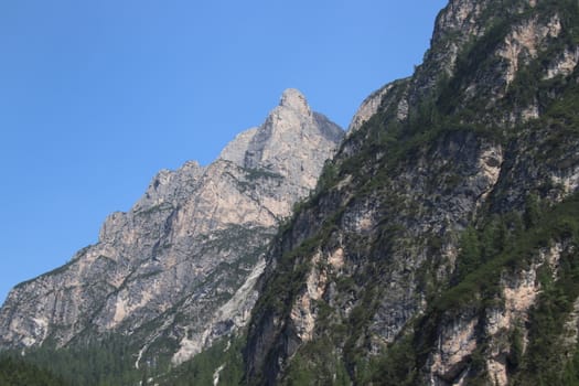 Rocky mountains with green forests at Lago di Braies. Braies lake in the Dolomites in South Tyrol, Italy, a municipality of Braies, in the Prague Valley.