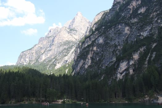 Rocky mountains with green forests at Lago di Braies. Braies lake in the Dolomites in South Tyrol, Italy, a municipality of Braies, in the Prague Valley.