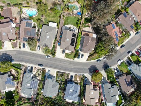 Aerial top view of upper middle class neighborhood street with residential house and swimming pool in San Diego, California, USA.