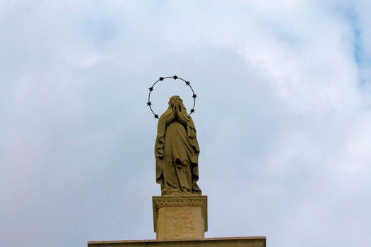 Golden Statue at Top of Church in Bergamo Italy