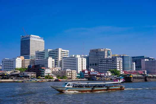 Bangkok,Thailand - May 21, 2019 : Passenger boat in Chaophaya river passing through Siriraj Hospital with clear blue sky