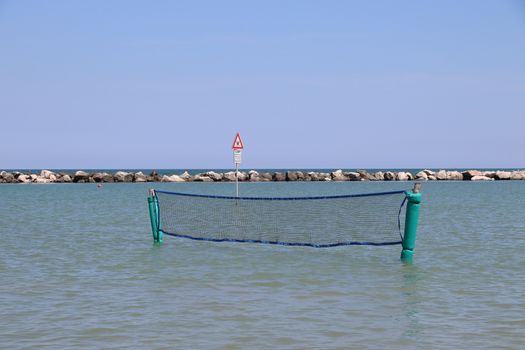 Empty volleyball net  on the sea  in summer.