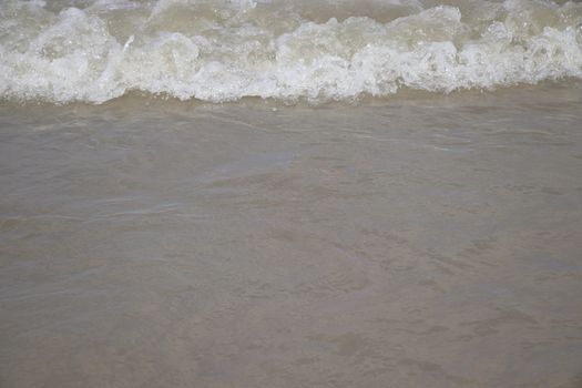 view of the blue ocean waves on the beach.