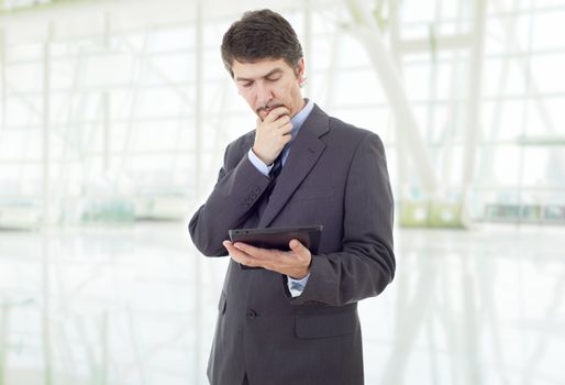 businessman thinking with a tablet pc, at the office