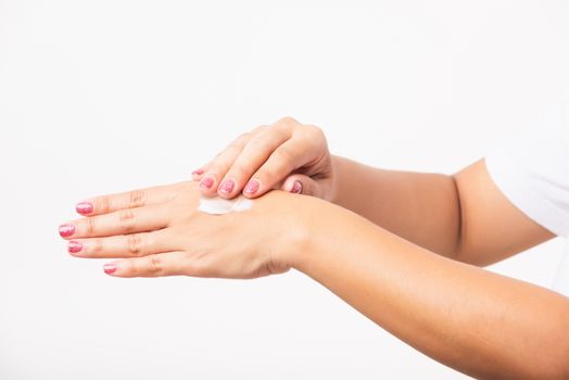 Closeup young Asian woman applying lotion cosmetic moisturizer cream on her behind the palm skin hand, studio shot isolated on white background, Healthcare medical and hygiene skin body care concept