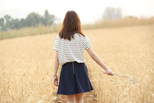 Young woman in wheat