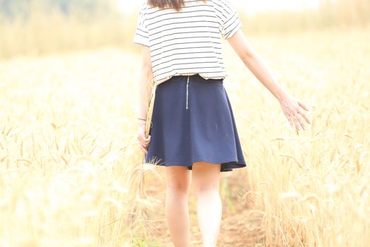 Young woman in wheat