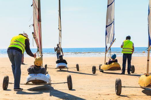 Saint Jean de Monts, France - September 23, 2017 : group of people taking a lesson of sand yachting on the beach at the end of summer
