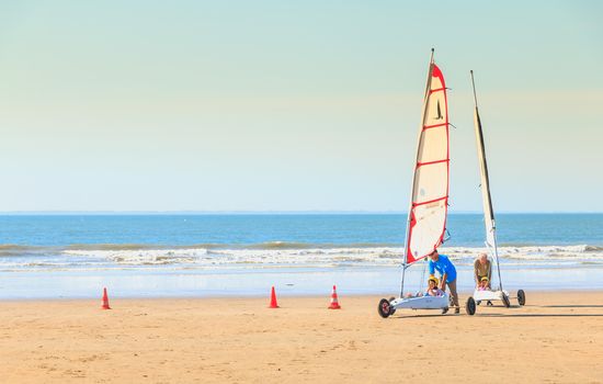 Saint Jean de Monts, France - September 23, 2017 : trainer gives a lesson of sand yachting at the beach at the end of the summer