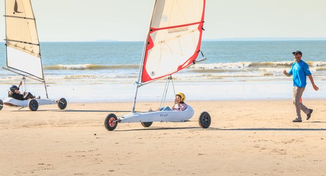 Saint Jean de Monts, France - September 23, 2017 : trainer gives a lesson of sand yachting at the beach at the end of the summer