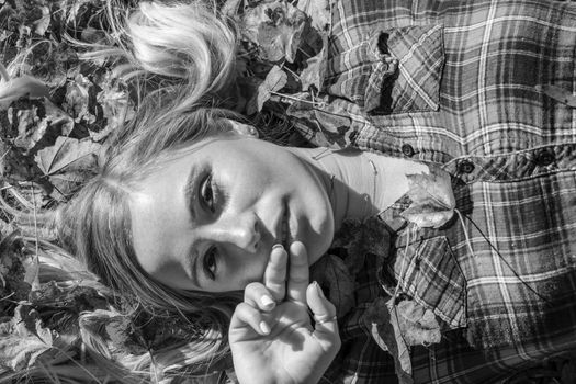 A gorgeous blonde model enjoys a Autumn day outdoors in a park