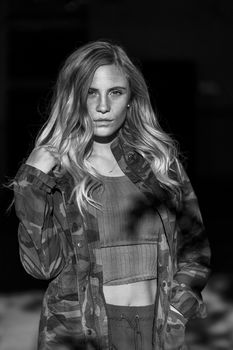 A gorgeous blonde model poses in a parking deck on an autumn day
