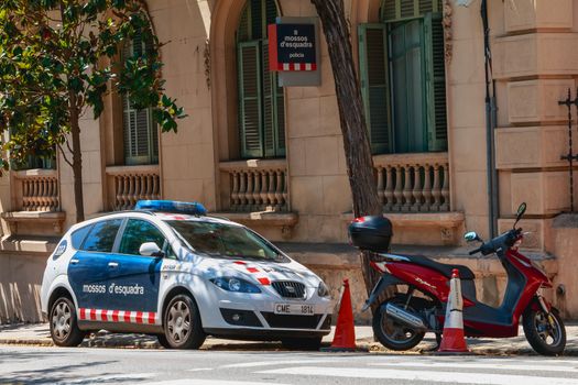 Barcelona, Spain - June 20, 2017: Police car parked in front of a small police station on a summer day