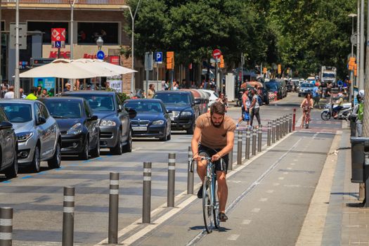 Barcelona, Spain - June 21, 2017 : cyclist riding on a bike lane on a summer day