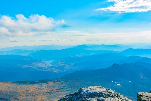 View from top of Mount Washington across mountainous landscape in New Hampshire USA.