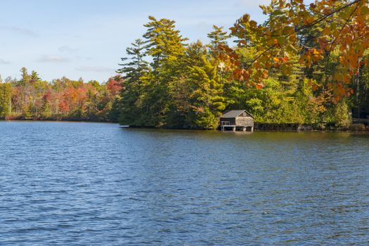 Beautiful autumn colors of surrounding woodlands of Lake Echo, Maine, USA. Highway 17.