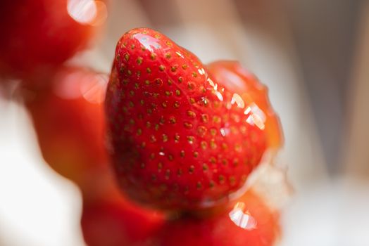 Tanghulu traditional Chinese hard caramel coated strawberry skewers close-up also called bing tanghulu candied hawthorn sticks