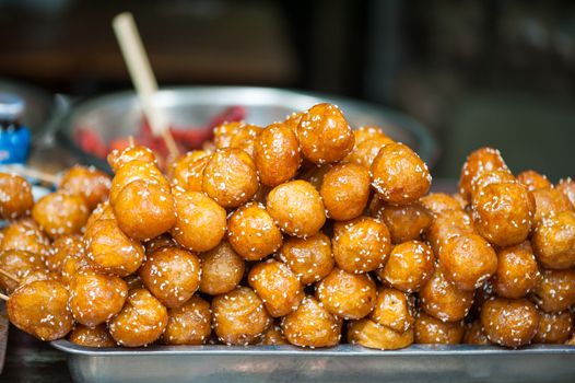 Fried sesame sweet sticky rice balls skewers - Tang You Guo Zi - Chengdu, Sichuan province, China