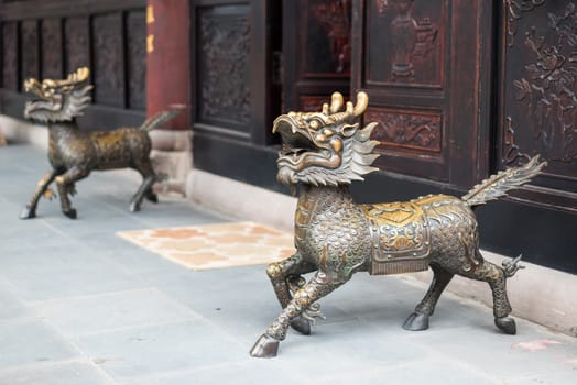 Bronze dragon statues at the entry of a buddhist temple in Chengdu, China