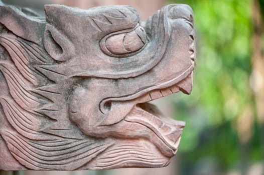 Stone dragon head scultpure close-up in a buddhist temple, China