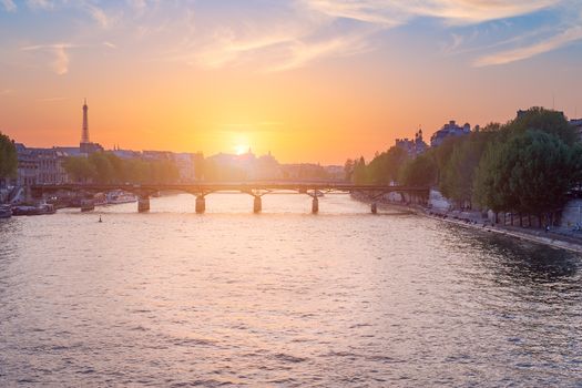 Paris skyline at sunset with river Seine in the foreground, France