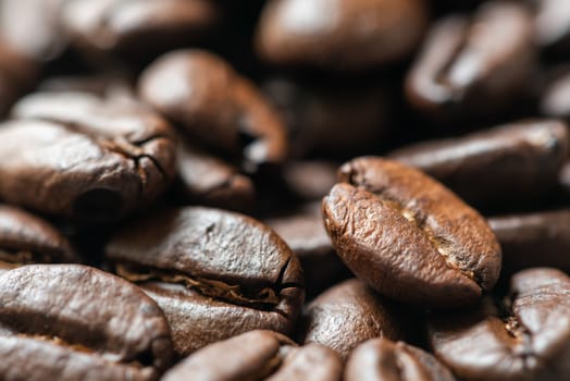 Heap of roasted coffee beans close-up view