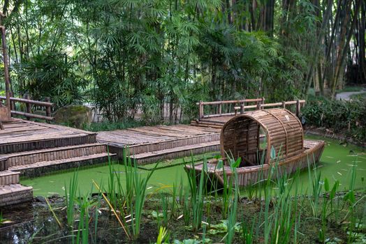 Abandoned chinese bamboo boat in green water, Chengdu, Sichuan province, China