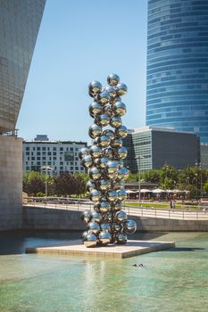 Bilbao, Spain - July 19, 2016 : under the summer sun, sculpture placed in front of the Guggenheim Museum named Tall Tree & The Eye, 2009 by Anish Kapoor