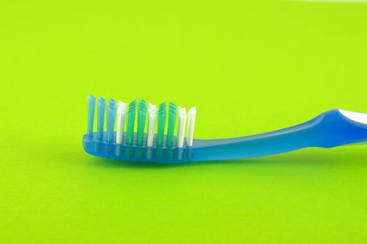 Tooth-brush over bright green