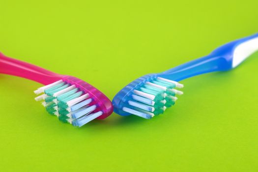 Two tooth-brushes over bright green